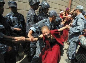 Tibetan Buddhist nun detained by Nepalese police during protests as the Chinese Olympic flame reached Lhasa, Tibet.
