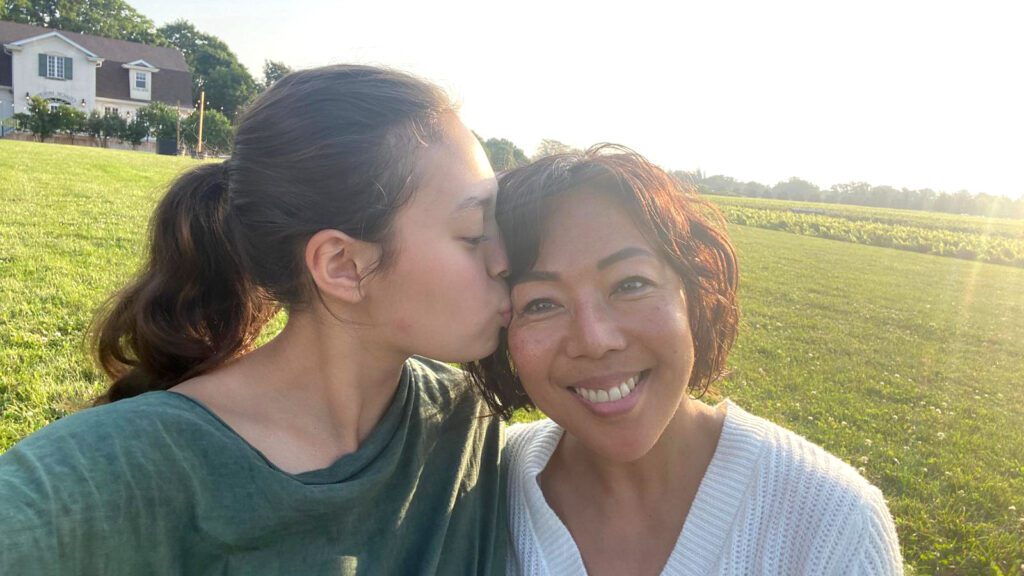 selfie of daughter kissing mom